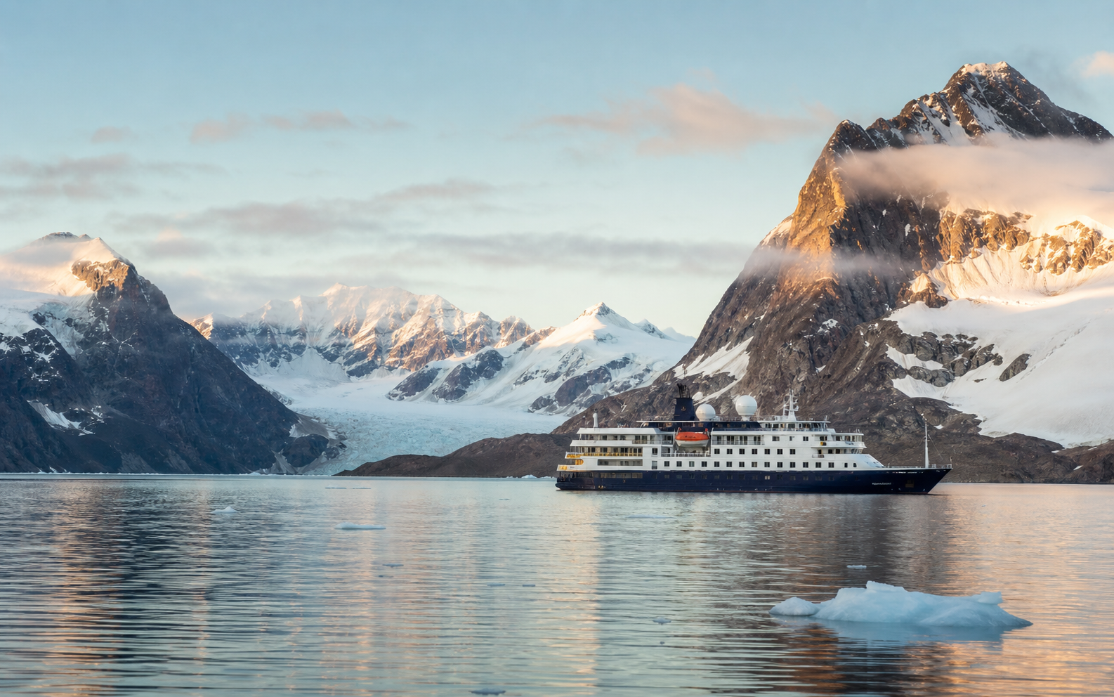 Luxury expedition cruise ship exploring a dramatic remote landscape